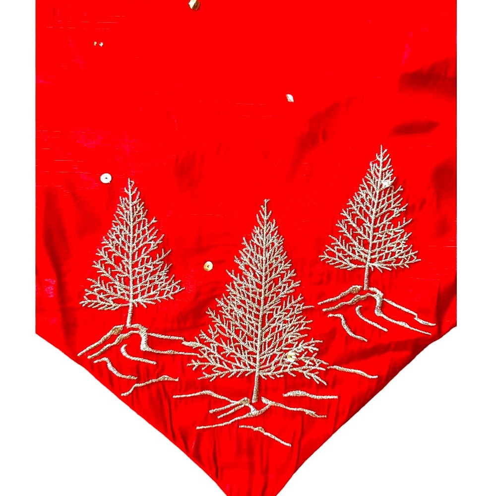 Red satin Christmas table runner with silver tree embellishments. So pretty.